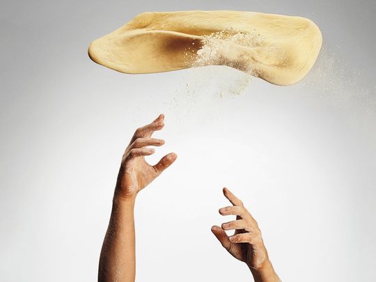 Hand-tossed pizza dough made fresh daily